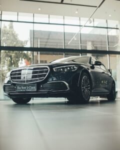 Elegant black car on display in a sleek and modern showroom, showcasing luxury design